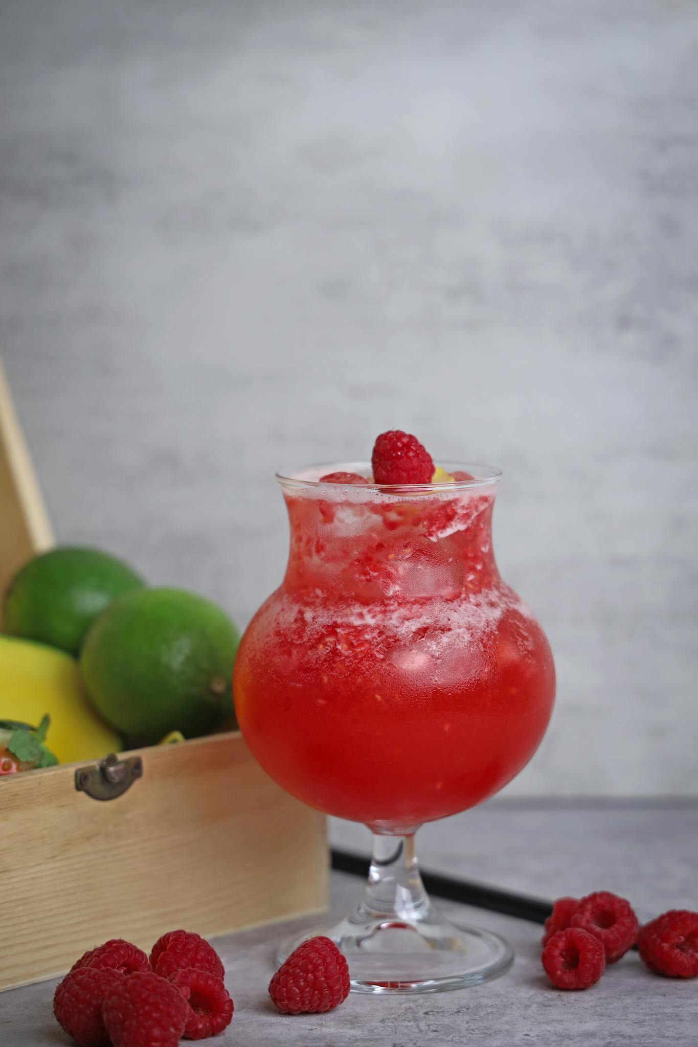 Delicious raspberry citrus drink in a glass with ice, perfect for refreshing summer vibes.